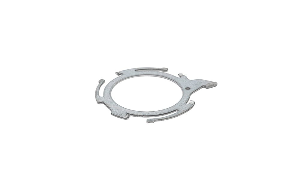 A flat, circular stamped metal ring with multiple tabs, slots, and cutouts on a white background.