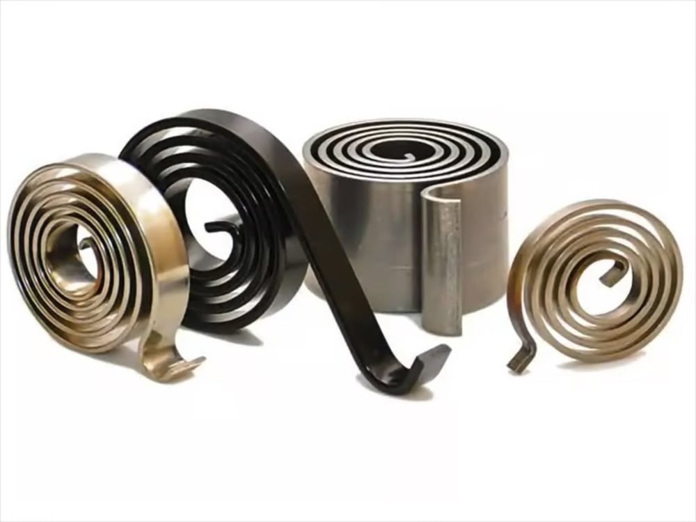 Coiled metal springs of various sizes and colors, including black and gold, are displayed