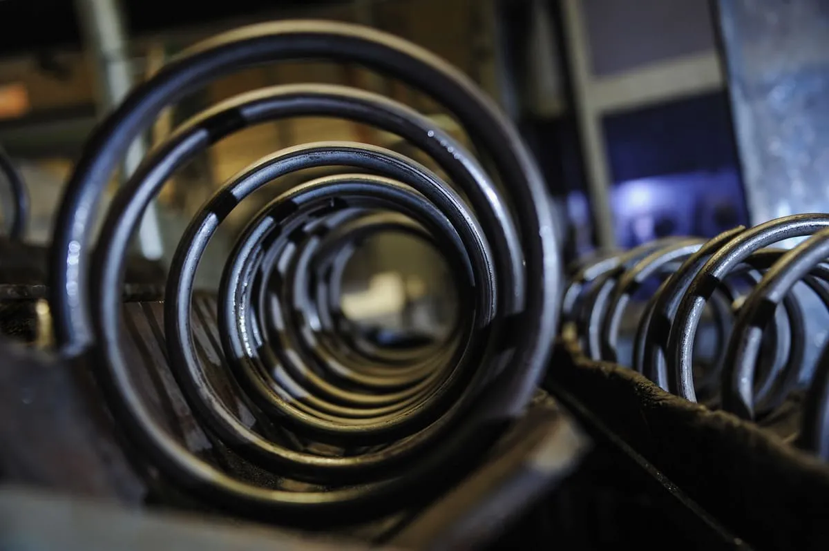 A close-up image of compression springs on a shelf post-manufacture and Lesjöfors’ world-class production facility.