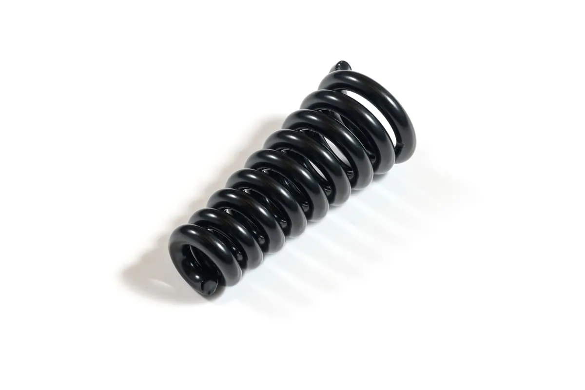 A black coated conical compression spring lying diagonally on a white background, tapering from a wider base to a narrower top.