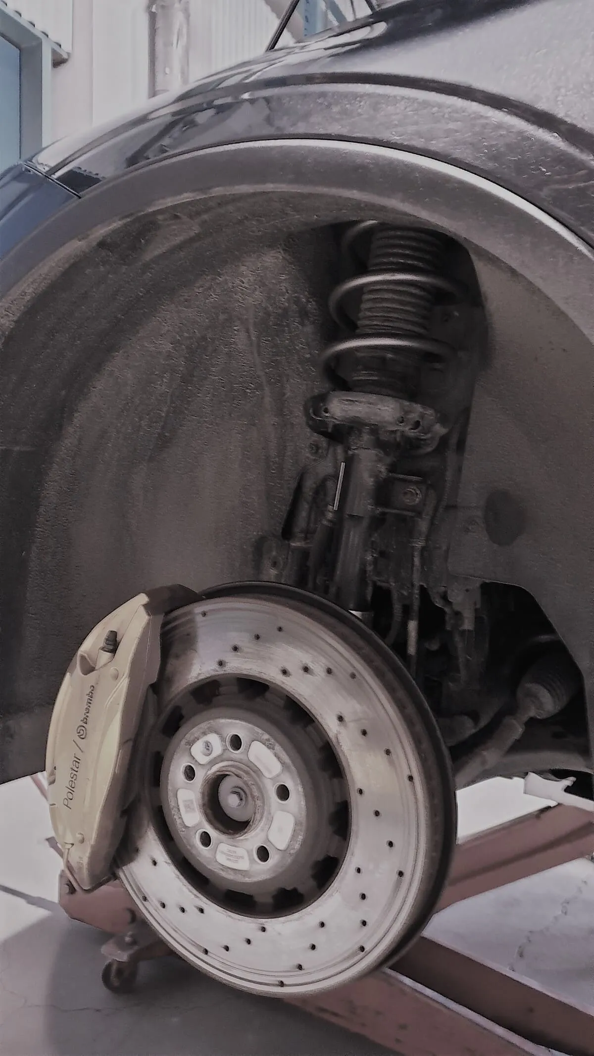 Close-up of the Polestar 2 wheel assembly and suspension system featuring custom-engineered Lesjöfors suspension springs.